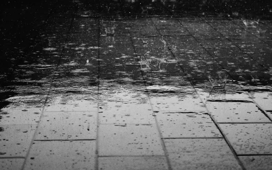 Rain pouring on pavement